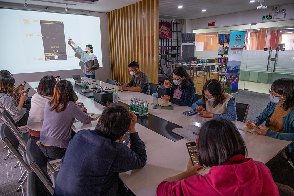 Conducting a 'WeCare' Smartwatch training for parent workers in a factory in China